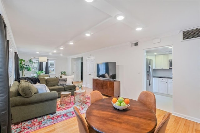 living area with crown molding, recessed lighting, visible vents, and light wood-type flooring
