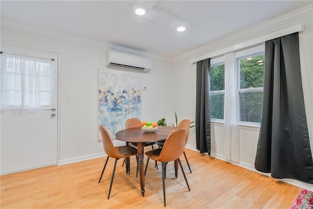dining space with light wood-style floors, baseboards, crown molding, and a wall unit AC