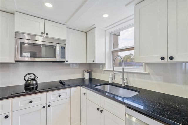kitchen with recessed lighting, a sink, white cabinetry, and appliances with stainless steel finishes