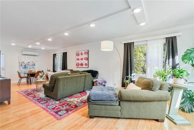 living room with an AC wall unit, light wood-style flooring, recessed lighting, baseboards, and ornamental molding