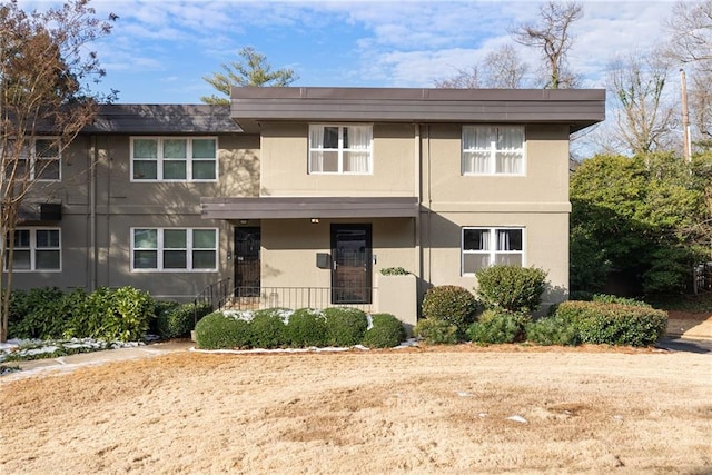view of front of property featuring a porch and stucco siding