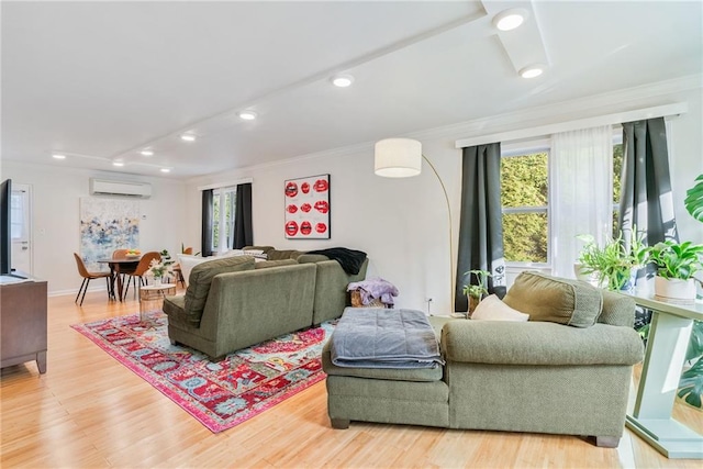 living area with recessed lighting, ornamental molding, light wood-style flooring, and a wall mounted air conditioner