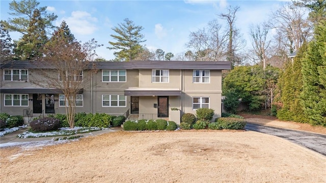 townhome / multi-family property featuring a porch and stucco siding