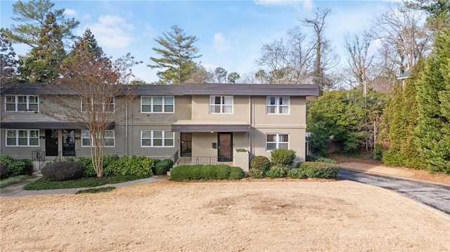 view of property with covered porch and stucco siding
