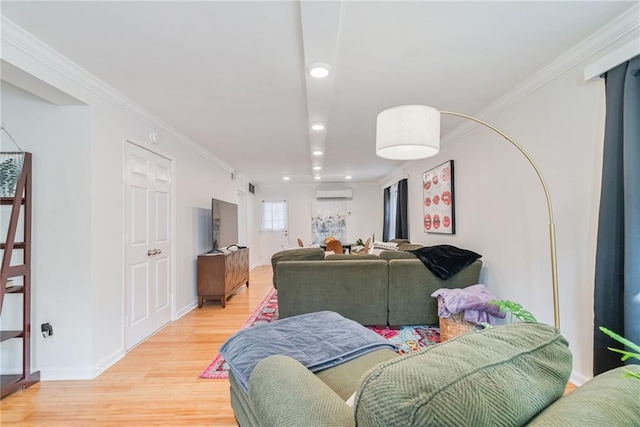 living room featuring an AC wall unit, ornamental molding, light wood finished floors, and recessed lighting