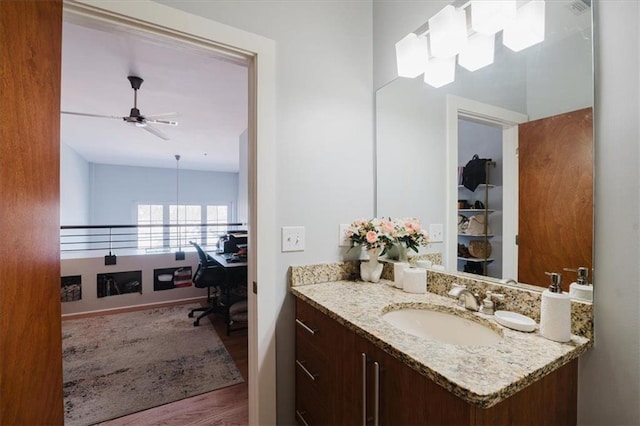 bathroom with wood finished floors, ceiling fan, and vanity