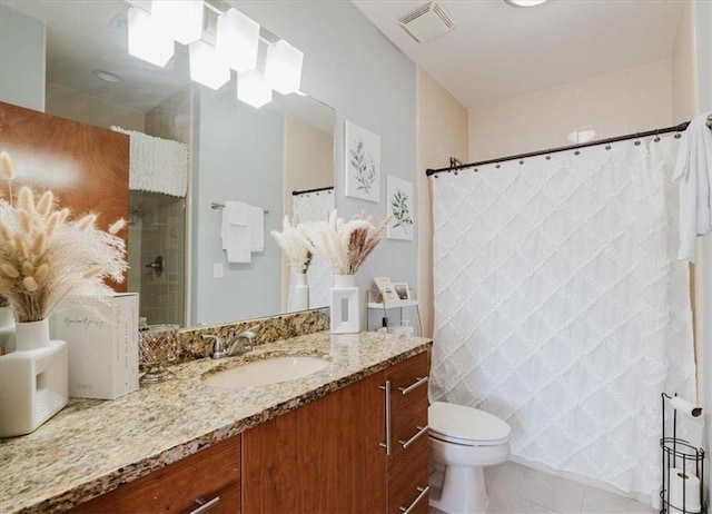 bathroom featuring visible vents, a shower with shower curtain, toilet, vanity, and tile patterned flooring