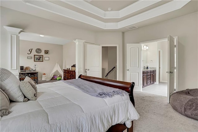 bedroom featuring visible vents, decorative columns, light colored carpet, and a raised ceiling