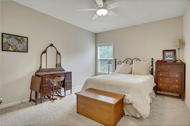 carpeted bedroom with visible vents, baseboards, and a ceiling fan
