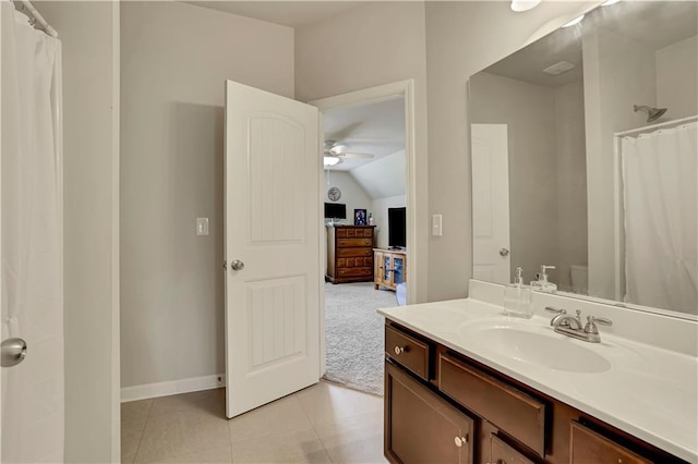 bathroom with vanity, baseboards, curtained shower, a ceiling fan, and lofted ceiling