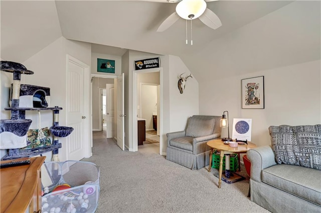 carpeted living area with baseboards, a ceiling fan, and lofted ceiling