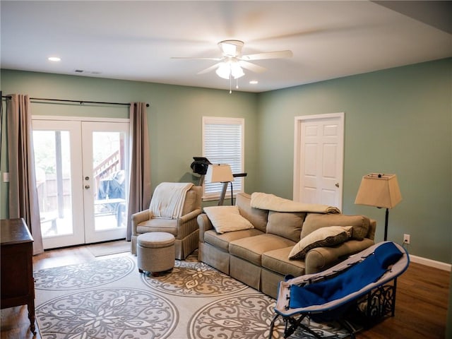 living room featuring french doors, ceiling fan, wood finished floors, and a wealth of natural light