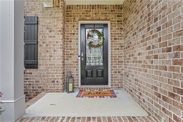 doorway to property with brick siding