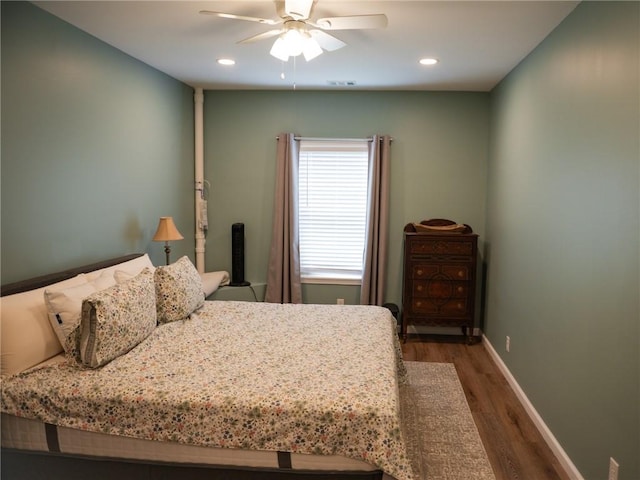 bedroom featuring wood finished floors, baseboards, visible vents, and recessed lighting