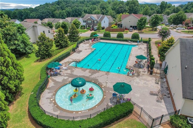 view of pool with a residential view and fence