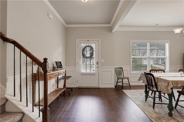 entryway with wood finished floors, ornamental molding, stairway, and a wealth of natural light