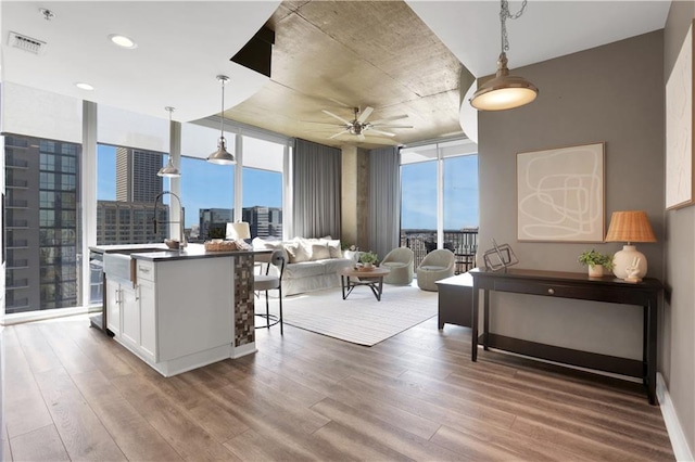 855 Peachtree St NE Unit 1703, Atlanta, GA 30308 - living room featuring wood finished floors, ceiling fan, expansive windows, a city view, and recessed lighting
