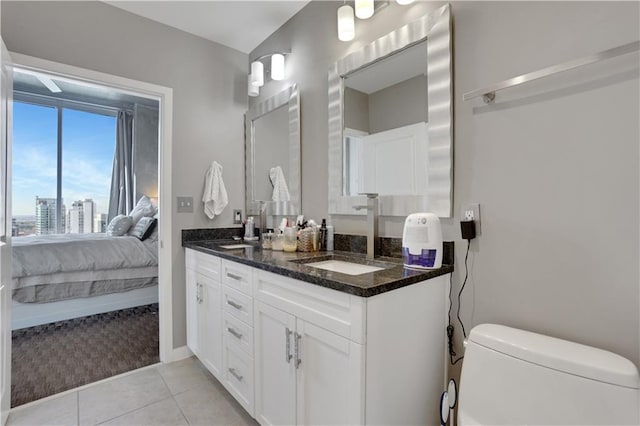 855 Peachtree St NE Unit 1703, Atlanta, GA 30308 - bathroom with toilet, double vanity, connected bathroom, and tile patterned flooring