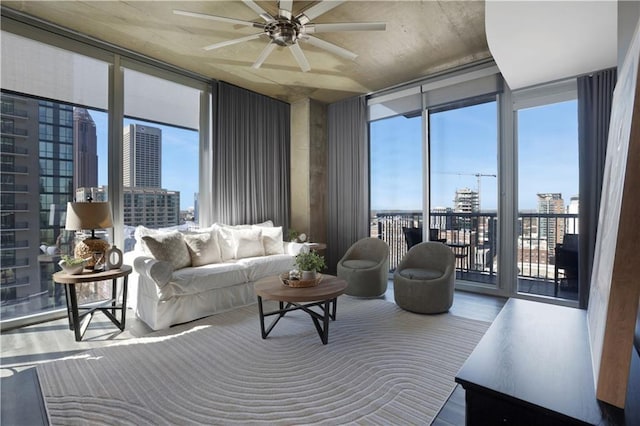 855 Peachtree St NE Unit 1703, Atlanta, GA 30308 - living area with expansive windows, a view of city, plenty of natural light, a ceiling fan, and wood finished floors