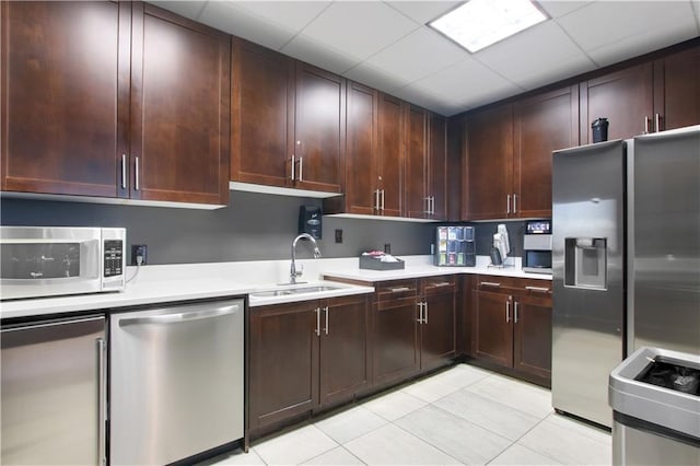 855 Peachtree St NE Unit 1703, Atlanta, GA 30308 - kitchen with stainless steel appliances, a sink, light countertops, light tile patterned floors, and dark brown cabinets