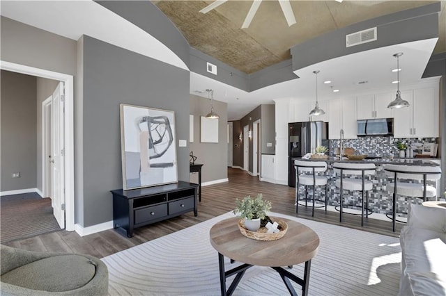 855 Peachtree St NE Unit 1703, Atlanta, GA 30308 - living room featuring dark wood-style flooring, baseboards, and a ceiling fan