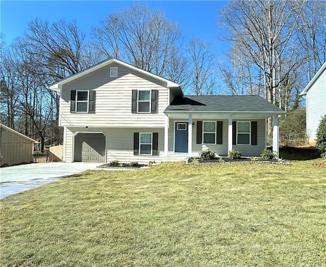 tri-level home with a garage, a front lawn, and a porch