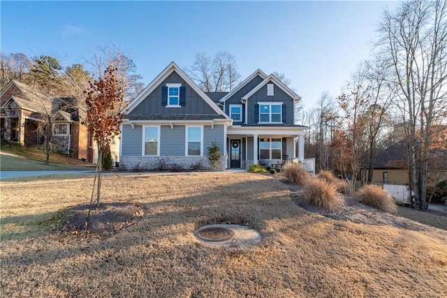 craftsman inspired home featuring covered porch and a front lawn