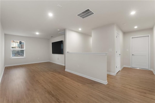 unfurnished room with hardwood / wood-style floors