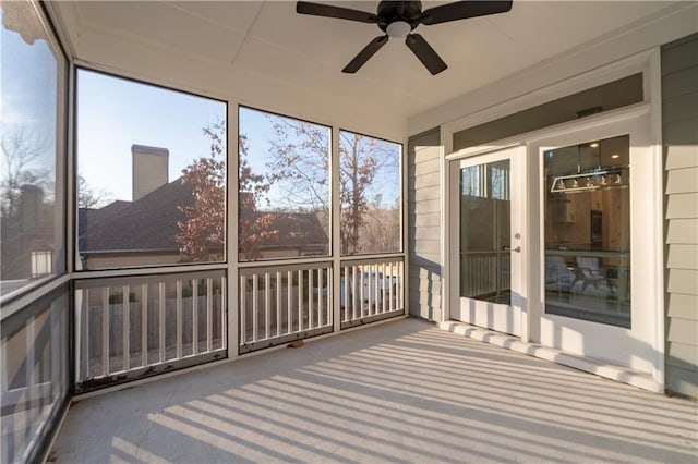 unfurnished sunroom with ceiling fan