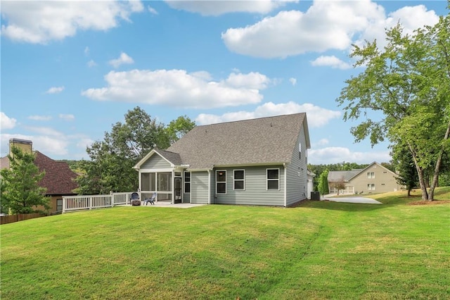 rear view of house featuring a sunroom, a yard, cooling unit, and a patio area