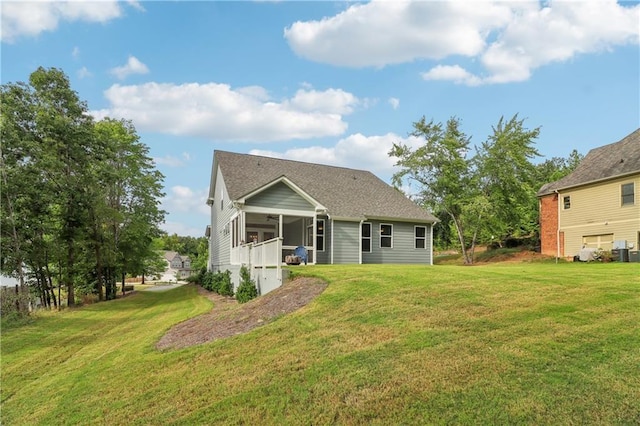 back of property with a lawn