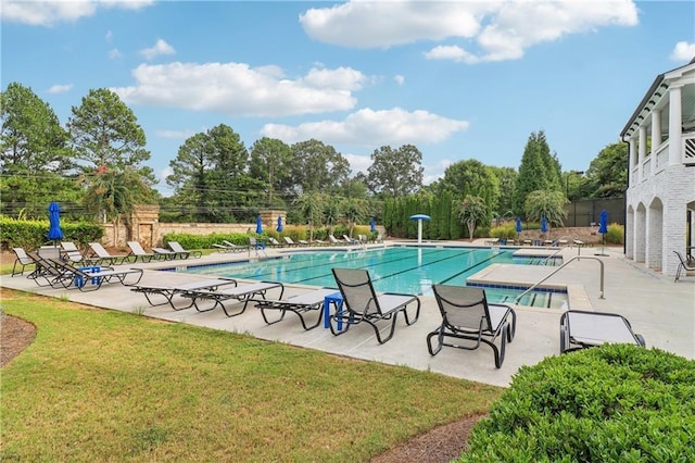 view of swimming pool with a lawn and a patio area