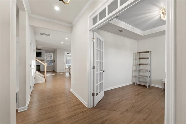 corridor featuring crown molding, dark wood-type flooring, and french doors