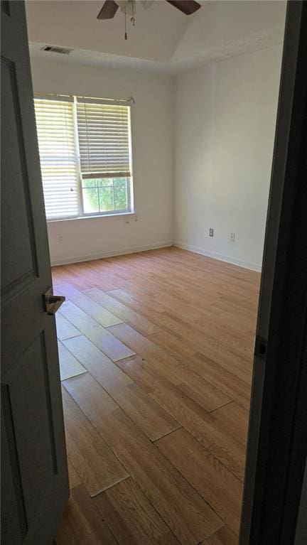 unfurnished room with baseboards, ceiling fan, light wood-type flooring, and visible vents