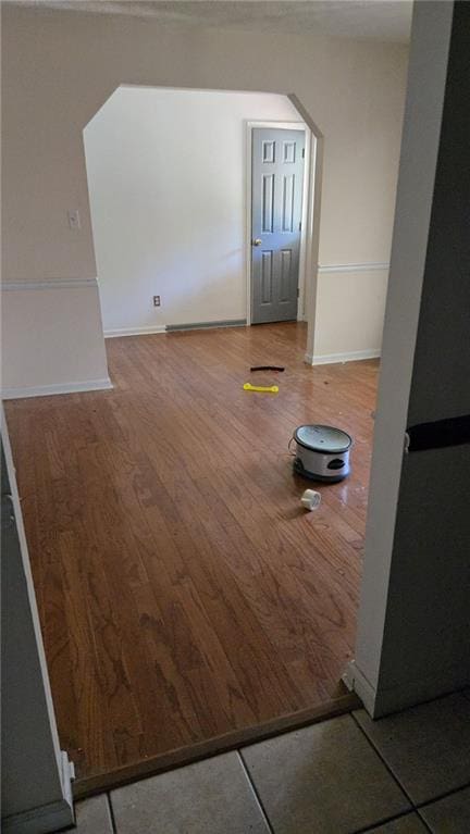 unfurnished room with baseboards and wood finished floors