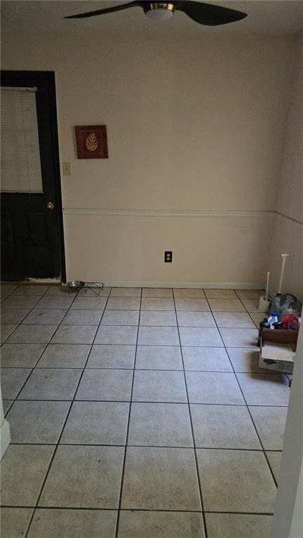 empty room with light tile patterned floors and ceiling fan