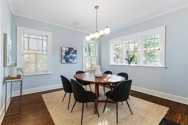 dining space featuring dark hardwood / wood-style flooring, ornamental molding, and a notable chandelier