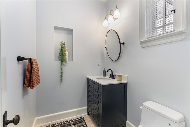 bathroom featuring toilet and vanity