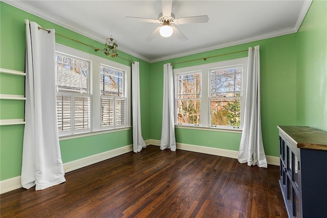 empty room with ceiling fan, crown molding, and dark wood-type flooring