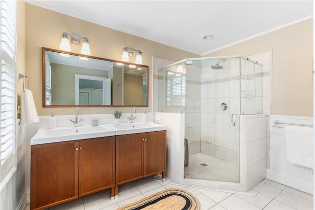 bathroom with a shower with door, ornamental molding, tile patterned floors, and vanity