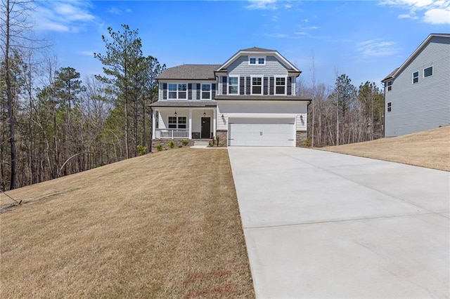 view of front facade with a garage, a front lawn, covered porch, stone siding, and driveway
