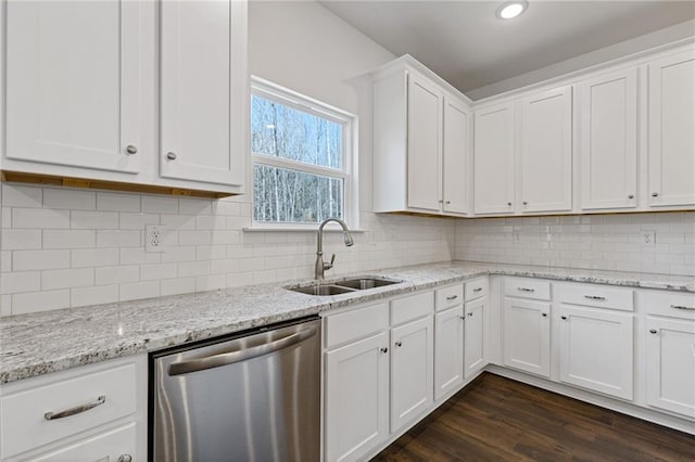 kitchen with white cabinets, a sink, dishwasher, backsplash, and dark wood-style floors