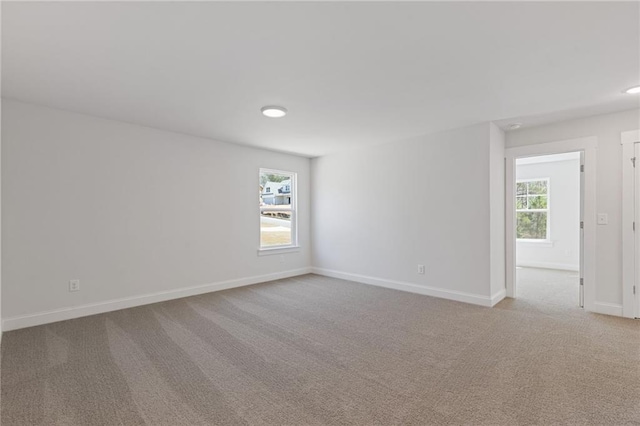 carpeted empty room with baseboards and recessed lighting