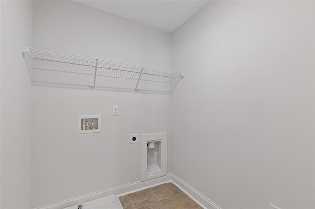 laundry area with laundry area, hookup for a washing machine, tile patterned floors, baseboards, and electric dryer hookup