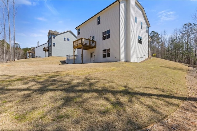 back of property featuring a yard and a deck