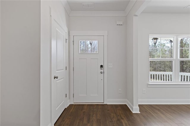 entrance foyer with baseboards, ornamental molding, dark wood-style floors, and visible vents