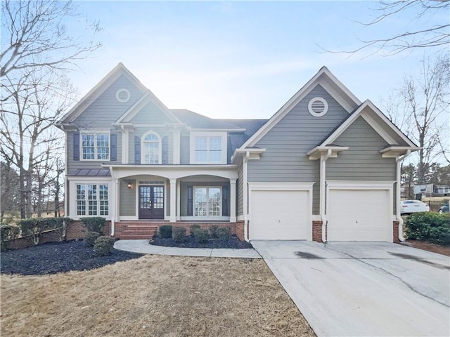 view of front of property with a garage, driveway, and brick siding