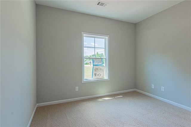 carpeted empty room featuring visible vents and baseboards