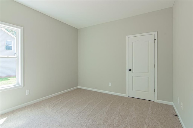 empty room with baseboards and carpet floors