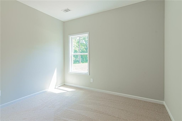 carpeted empty room with baseboards and visible vents